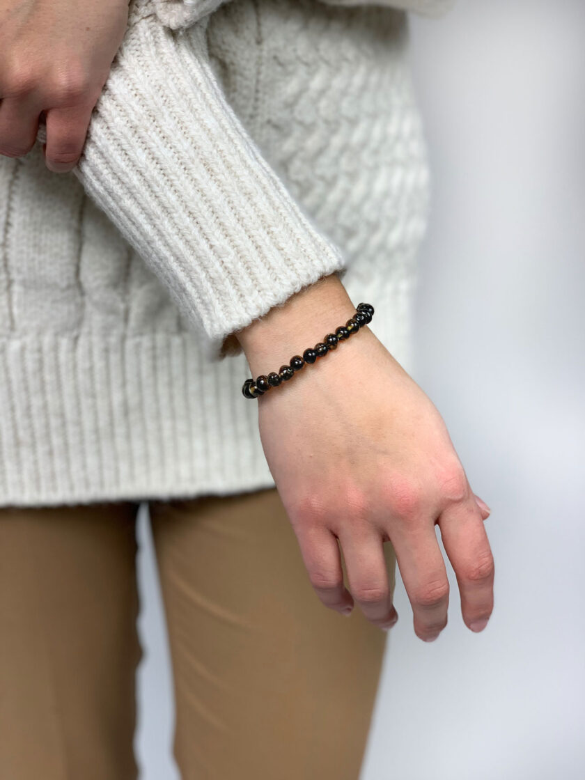 woman wearing green amber bracelet