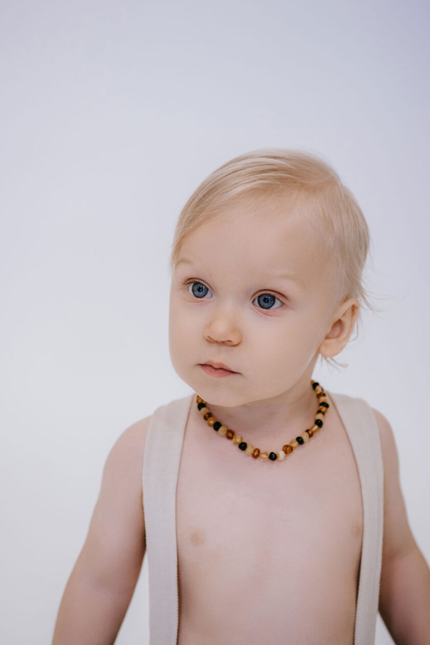polished colourful amber teething necklace on baby