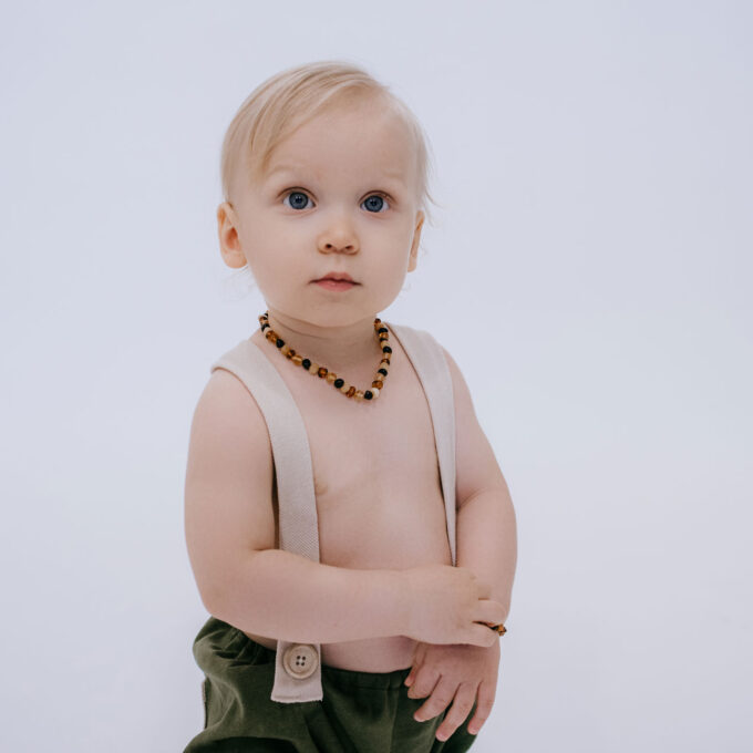 baby wearing mixed amber teething necklace