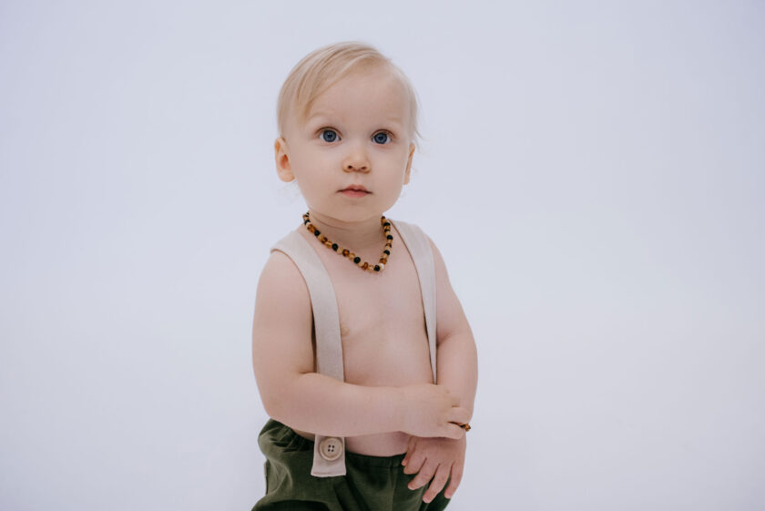 baby wearing mixed amber teething necklace