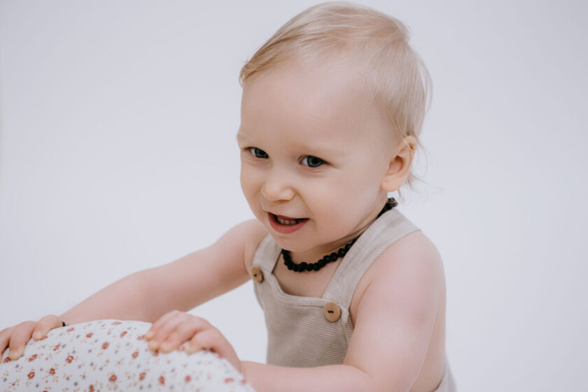 baby with raw black amber necklace for teething