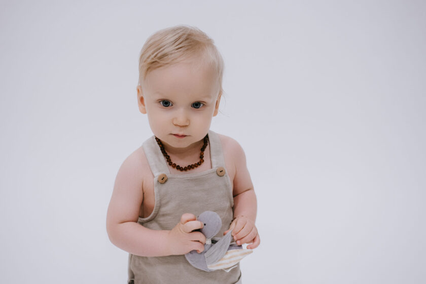 baby wearing raw cognac colour amber teething necklace