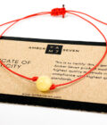 red string bracelet with amber